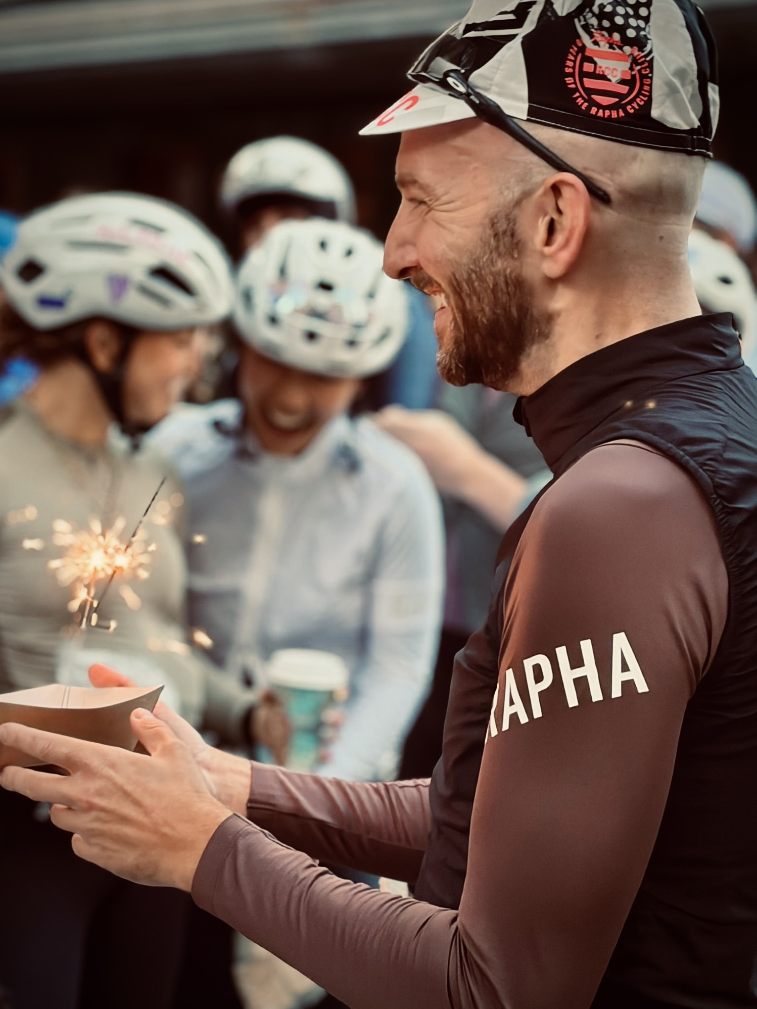 Sam Sutherland in cycling kit with a group of cyclists